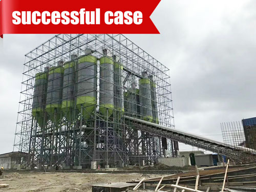 Enclosed concrete batch mixing plant with protected material transfer