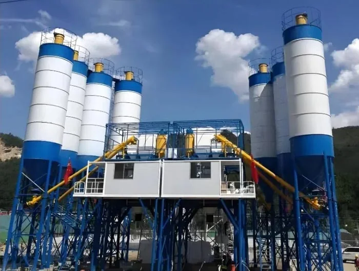 Complete dry batch concrete plant with aggregate bins, transfer system and cement silos