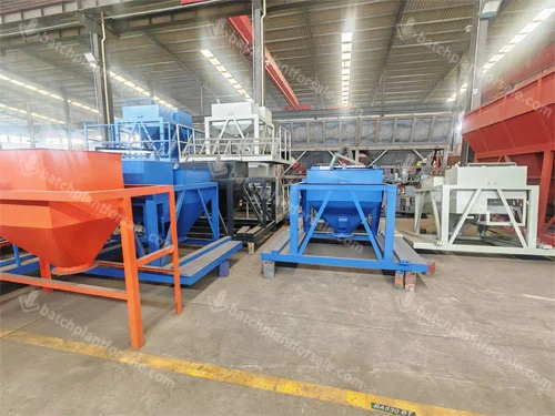 Water and admixture hopper assemblies shown in a batching-equipment workshop