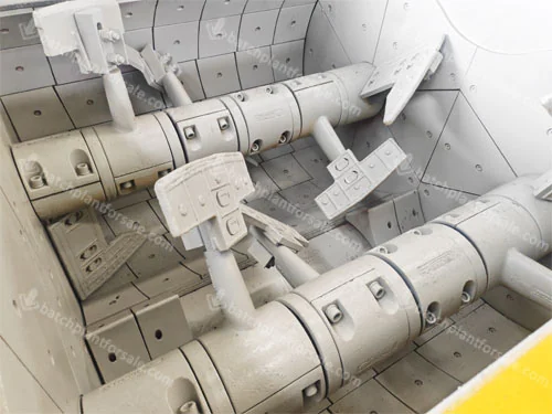 Twin-shaft mixer interior showing two shafts, mixing paddles and wear liners